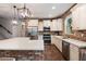 Bright and well-equipped kitchen with white cabinets, stainless steel appliances, and brick accent wall at 3944 W Paradise Ln, Phoenix, AZ 85053