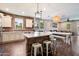Bright kitchen featuring brick accent wall, modern appliances, a large island and eating area at 3944 W Paradise Ln, Phoenix, AZ 85053
