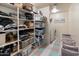 Functional laundry room with storage shelves, folding area, and washer/dryer hookups at 3944 W Paradise Ln, Phoenix, AZ 85053