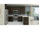 Modern kitchen featuring stainless steel appliances, a breakfast bar, and ample counter space at 4707 E French Rd, San Tan Valley, AZ 85143