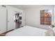 Bright bedroom featuring white walls and a large window, seamlessly transitioning into a cozy living room space at 4772 W Joshua Blvd, Chandler, AZ 85226