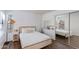 Cozy bedroom with wood-look floors, decorative mirror, and ample light from the large windows at 4772 W Joshua Blvd, Chandler, AZ 85226