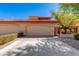 Exterior view features a large three-car garage, desert landscaping, and a decorative front gate at 4772 W Joshua Blvd, Chandler, AZ 85226
