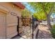 Wrought iron entry gate and courtyard with lush trees enhances the curb appeal of this well-maintained home at 4772 W Joshua Blvd, Chandler, AZ 85226