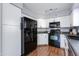 Spacious kitchen with ample white cabinets, black appliances, and laminate countertops at 4772 W Joshua Blvd, Chandler, AZ 85226