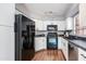 Functional kitchen with white cabinetry, black appliances, and laminate flooring at 4772 W Joshua Blvd, Chandler, AZ 85226