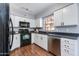 Well-lit kitchen boasts white cabinets, black appliances, and laminate countertops at 4772 W Joshua Blvd, Chandler, AZ 85226