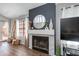 Cozy living room with a fireplace, stylish decor, and wood flooring, creating a warm and inviting atmosphere at 4772 W Joshua Blvd, Chandler, AZ 85226