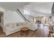 Inviting living room with a cozy couch, staircase, wood floors, and an open floor plan for comfortable modern living at 4772 W Joshua Blvd, Chandler, AZ 85226