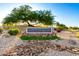 The Heritage Highlands community entrance featuring a stone sign, landscaping, and a decorative rock feature at 507 W Sweetwater Ave, Phoenix, AZ 85029