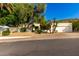 Charming home featuring desert landscaping, a two-car garage, and mature trees at 507 W Sweetwater Ave, Phoenix, AZ 85029