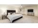 Main bedroom featuring a large bed, neutral decor, ceiling fan, and access to the bathroom at 507 W Sweetwater Ave, Phoenix, AZ 85029