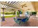 Covered patio featuring fans, brick flooring and an outdoor dining area near the green yard at 507 W Sweetwater Ave, Phoenix, AZ 85029