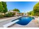 Sparkling pool with diving board surrounded by lush landscaping creates a resort-like backyard oasis at 507 W Sweetwater Ave, Phoenix, AZ 85029