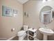Charming powder room featuring modern fixtures, a pedestal sink, and decorative wall art, enhancing style and functionality at 5345 W Alta Mesa Ave, Laveen, AZ 85339