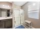 Well-lit bathroom with vanity, and glass-enclosed shower providing a modern and functional space for daily routines at 5345 W Alta Mesa Ave, Laveen, AZ 85339