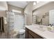 Bright bathroom featuring a shower-tub combo and vanity with a large mirror at 5345 W Alta Mesa Ave, Laveen, AZ 85339