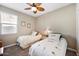 Charming bedroom with twin beds, a ceiling fan, and a window for natural light at 5345 W Alta Mesa Ave, Laveen, AZ 85339