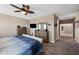 Spacious bedroom featuring wall-mounted TV, matching dressers, and ensuite bathroom, offering comfort and convenience at 5345 W Alta Mesa Ave, Laveen, AZ 85339