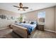 Serene bedroom boasting neutral tones, carpet floors, a ceiling fan, and bright windows for a calming retreat at 5345 W Alta Mesa Ave, Laveen, AZ 85339