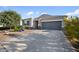 Charming single-story home with a gray stucco exterior, a two-car garage, and desert landscaping at 5345 W Alta Mesa Ave, Laveen, AZ 85339