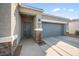 Close-up view of the home's front entry, highlighting the stylish door, stonework, and desert-friendly landscaping at 5345 W Alta Mesa Ave, Laveen, AZ 85339