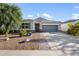 Well-maintained single-story home with xeriscape landscaping, a two-car garage, and a neutral color palette at 5345 W Alta Mesa Ave, Laveen, AZ 85339