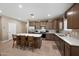 A spacious kitchen features stainless steel appliances, a center island with bar stool seating, and wooden cabinets at 5345 W Alta Mesa Ave, Laveen, AZ 85339