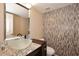Stylish half-bathroom featuring a vessel sink, granite countertop, and mosaic accent wall at 6023 E Scafell Cir, Mesa, AZ 85215