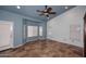 Bright bonus room with vaulted blue ceiling, large windows, and tile flooring at 6023 E Scafell Cir, Mesa, AZ 85215