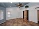 Bright bonus room featuring large windows, ceiling fan, tile flooring, and bathroom access at 6023 E Scafell Cir, Mesa, AZ 85215