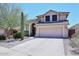 Two-story single Gathering home with a 2 car garage, tile roof and desert landscaping at 6023 E Scafell Cir, Mesa, AZ 85215