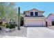 Charming two-story home featuring desert landscaping and a spacious two-car garage at 6023 E Scafell Cir, Mesa, AZ 85215
