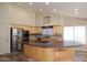 Spacious kitchen with stainless steel appliances, cooktop, and a large center island at 6023 E Scafell Cir, Mesa, AZ 85215