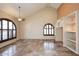 Bright living room featuring vaulted ceilings, tile floors, and custom built-ins at 6023 E Scafell Cir, Mesa, AZ 85215