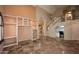 Spacious living room with tile floors, built-in shelves, and staircase at 6023 E Scafell Cir, Mesa, AZ 85215