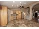 Open living area featuring a staircase, built-in cabinets, and access to kitchen at 6023 E Scafell Cir, Mesa, AZ 85215