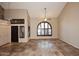 Open living room with tile floors, vaulted ceilings, and large arched windows at 6023 E Scafell Cir, Mesa, AZ 85215