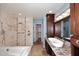 Bright main bathroom featuring soaking tub, walk-in shower, double sinks, and vanity at 6023 E Scafell Cir, Mesa, AZ 85215
