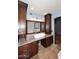 Elegant main bathroom featuring double sinks, granite countertops, and custom wood cabinetry at 6023 E Scafell Cir, Mesa, AZ 85215