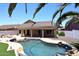 Backyard with a refreshing pool perfect for enjoying sunny days, framed by palm trees at 6023 E Scafell Cir, Mesa, AZ 85215