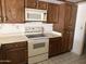 Kitchen featuring standard appliances and wood cabinets at 6320 W Del Mar Ln, Glendale, AZ 85306