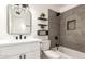 Modern bathroom with a stylish vanity, sleek fixtures, and a beautifully tiled shower-tub combination at 6813 E Diamond St, Scottsdale, AZ 85257