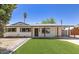 Charming single-story home featuring a modern door, new artificial turf, and a covered carport at 6813 E Diamond St, Scottsdale, AZ 85257