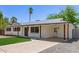 Inviting single-story home with a covered carport, low-maintenance landscaping, and an attractive modern door at 6813 E Diamond St, Scottsdale, AZ 85257