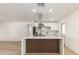 Bright kitchen features a large waterfall island with modern stainless steel appliances and white cabinets at 6813 E Diamond St, Scottsdale, AZ 85257