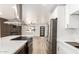 Open-concept kitchen with stainless steel appliances, quartz countertops, and a view into the living area at 6813 E Diamond St, Scottsdale, AZ 85257