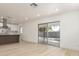 Open-concept living room featuring a sliding glass door with access to the backyard and bright wood floors at 6813 E Diamond St, Scottsdale, AZ 85257
