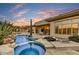 Expansive backyard boasting a gorgeous pool with spa, lush desert landscaping, covered patio, and outdoor dining at 7315 E Brisa Dr, Scottsdale, AZ 85266