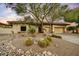 Attractive home exterior with desert landscaping, mature trees, and a well-maintained yard at 7315 E Brisa Dr, Scottsdale, AZ 85266